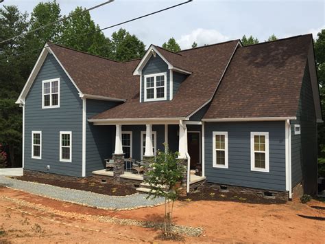 brown metal roof dark blue house white shutters|brown and blue exterior ideas.